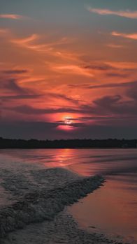Vibrant sunset reflecting on the Amazon River, capturing the serene beauty of nature.