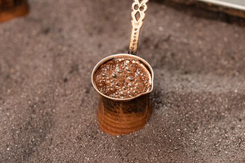 Free Close-up of Turkish coffee brewing in a copper cezve, showcasing rich foam and traditional preparation. Stock Photo