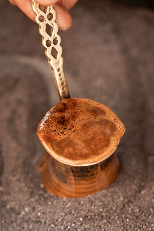 Free Close-up of Turkish coffee brewing in an ibrik, highlighting rich foam and ornate handle. Stock Photo