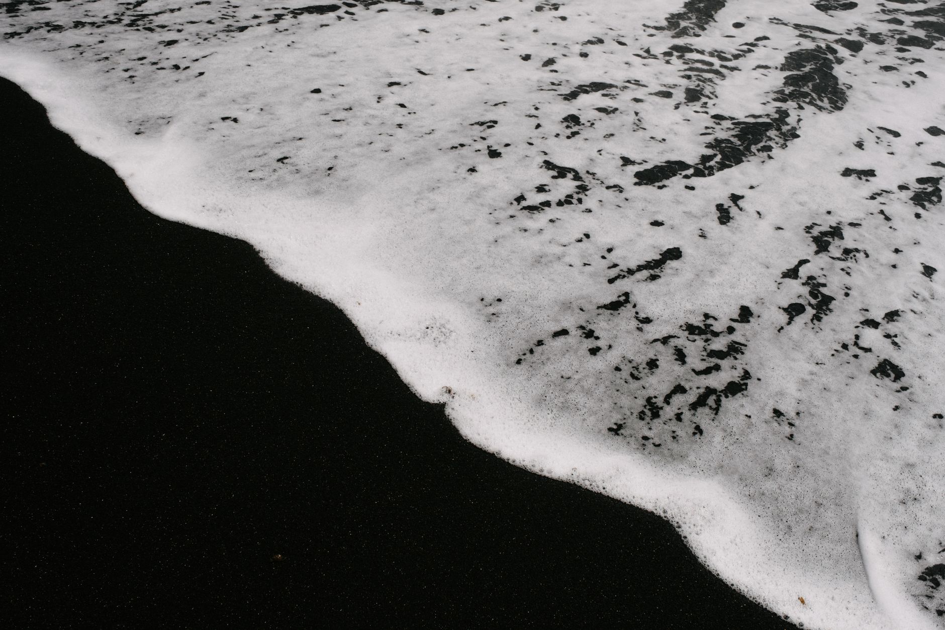 Waves washing over black sand, capturing contrast at Lanzarote's beach.. waves, washing, over