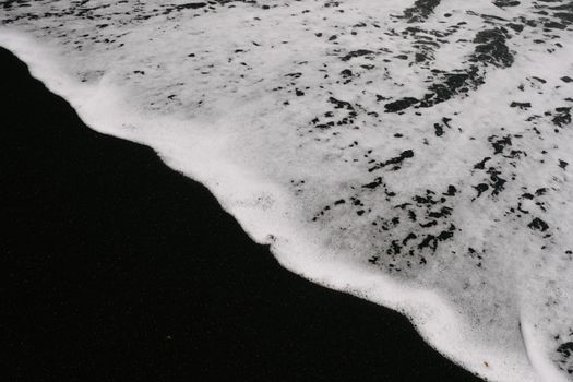 Waves washing over black sand, capturing contrast at Lanzarote's beach.. waves, washing, over