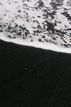 Captivating view of black sand beach being washed by ocean waves in Lanzarote, Spain.. pexels, captivating, view