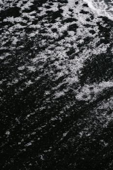 Captivating black sand beach with intricate wave patterns, showcasing natural beauty and texture.. pexels, captivating, black