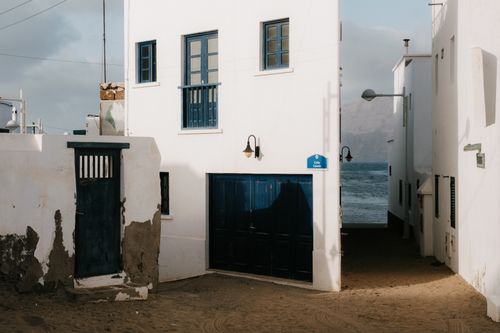 Free Traditional whitewashed buildings by the sea in Caleta de Famara, Lanzarote. Stock Photo