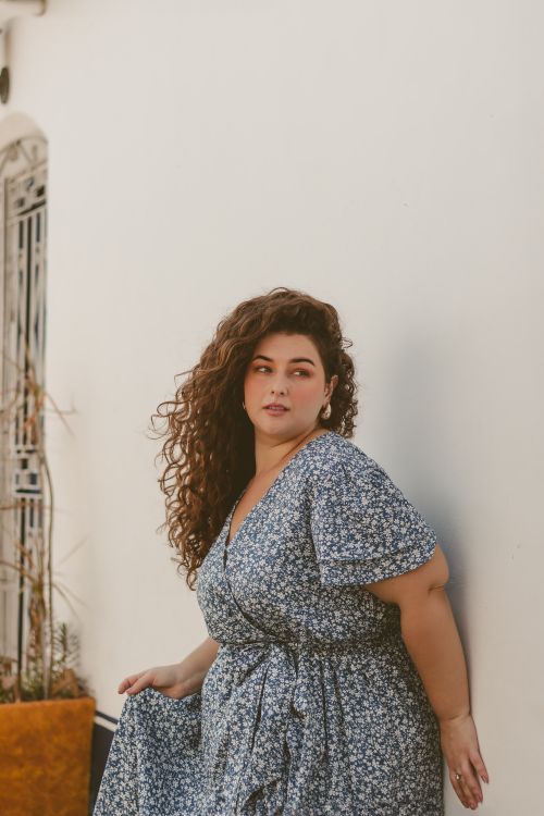 Woman in dark floral wrap dress