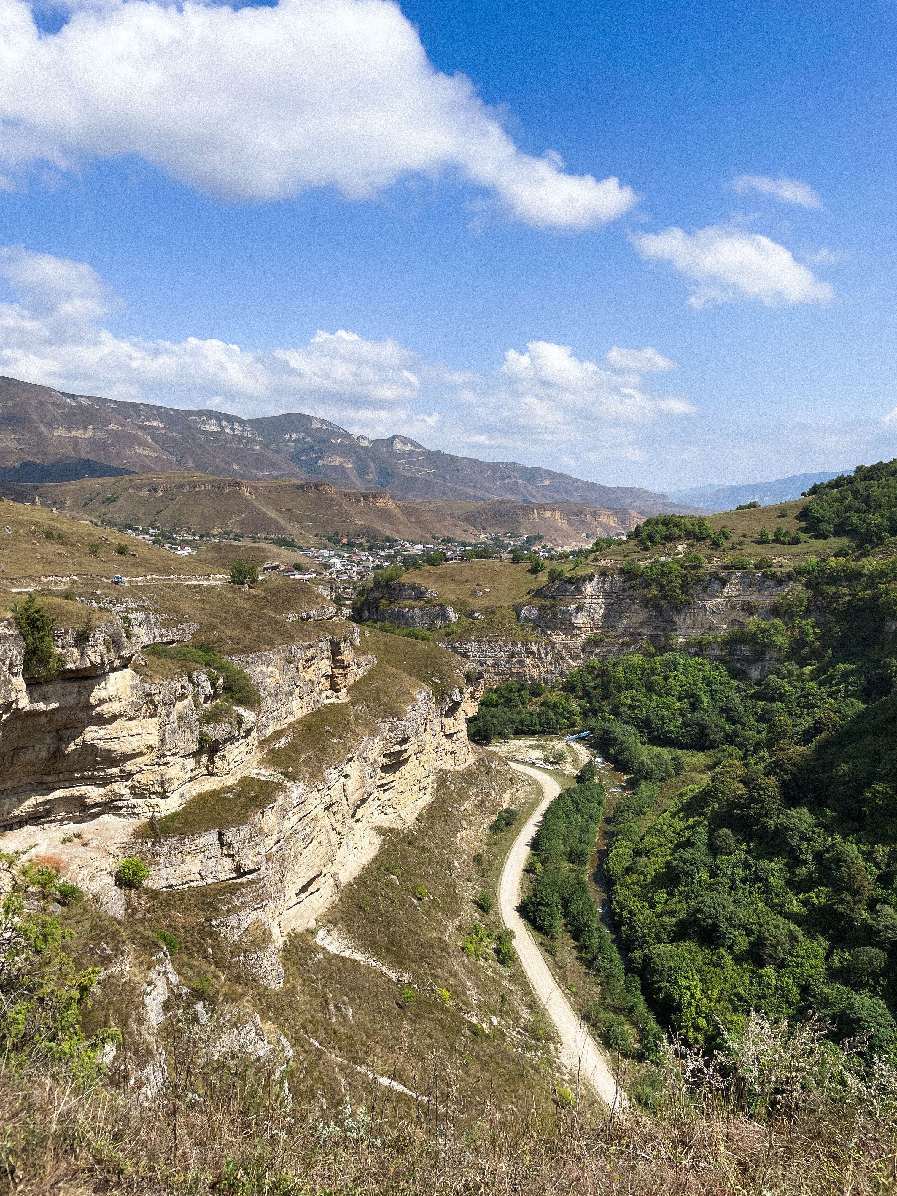 Scenic Mountain Landscape with Winding Road · Free Stock Photo