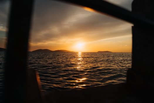 Capture the beauty of a sunset over the ocean with calming waves and a golden horizon.