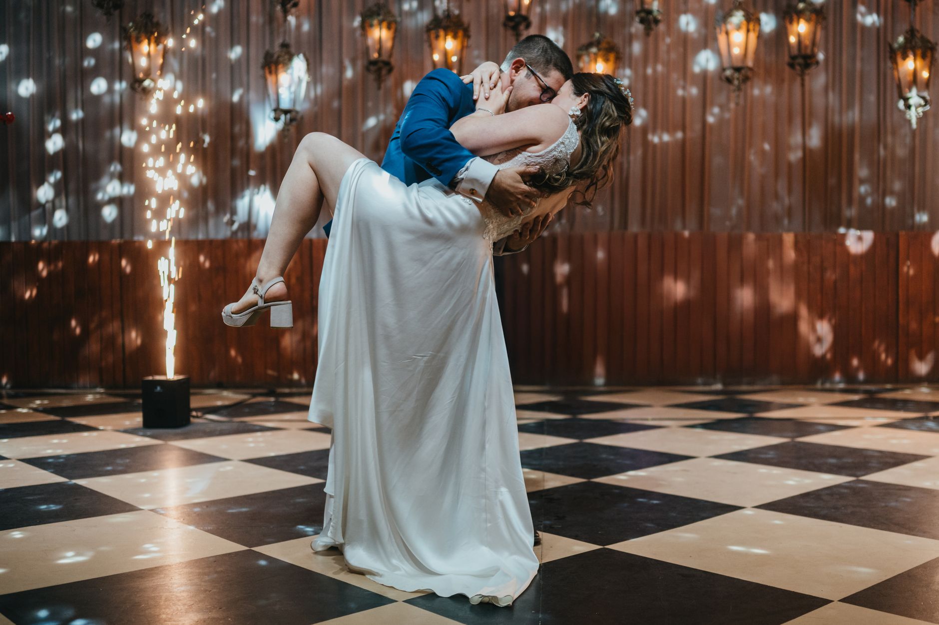 Wedding DJ vs Live Band: Find Your Reception Sound Bride and groom share a romantic dance with indoor fireworks at their wedding reception.