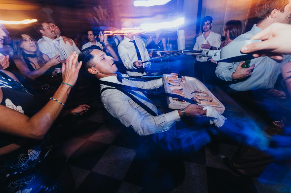 wedding guests dancing limbo celebration