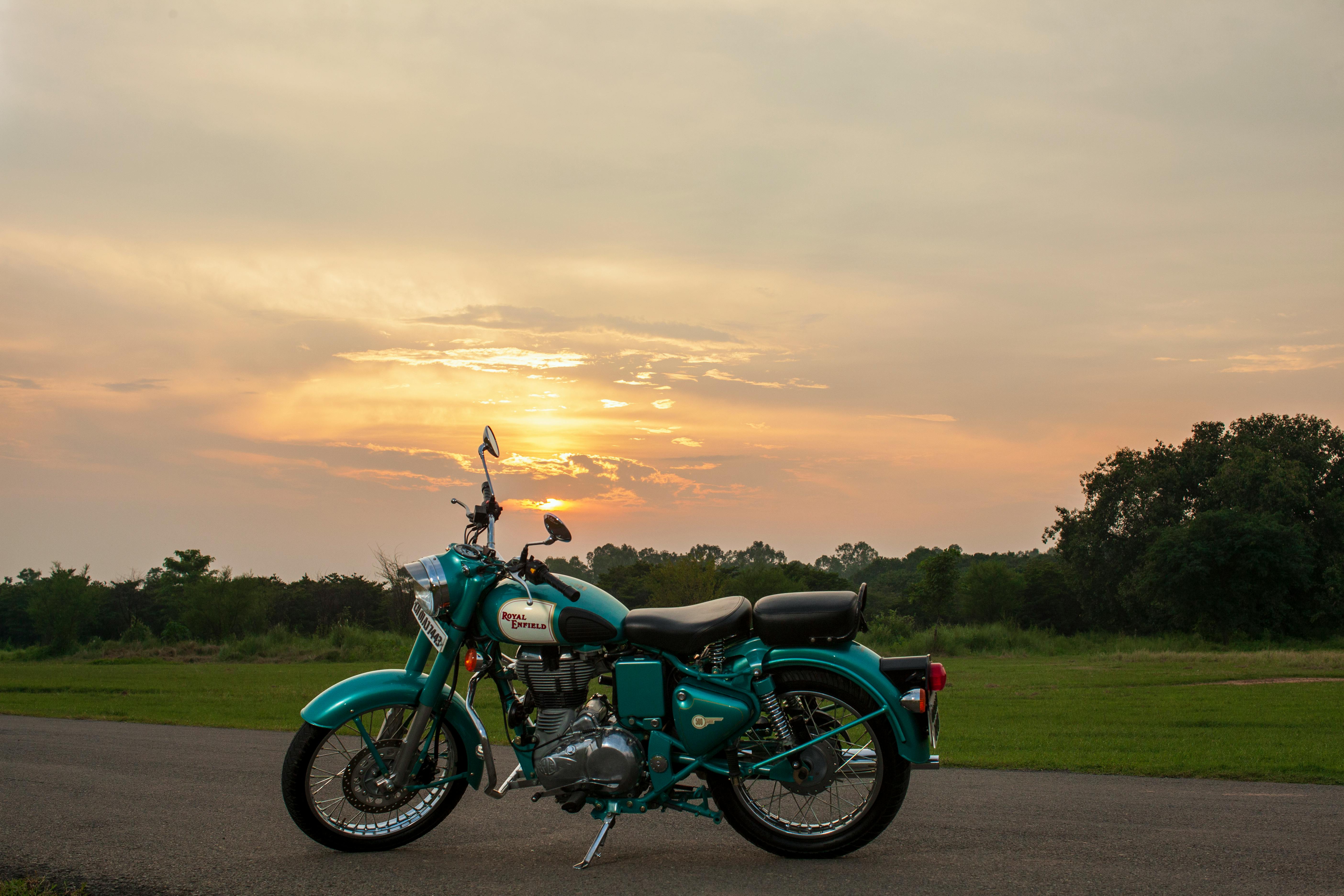 image of a motorcycle parked with a beautiful sunset in the background, conveying a sense of freedom and confidence - best motorcycle insurance