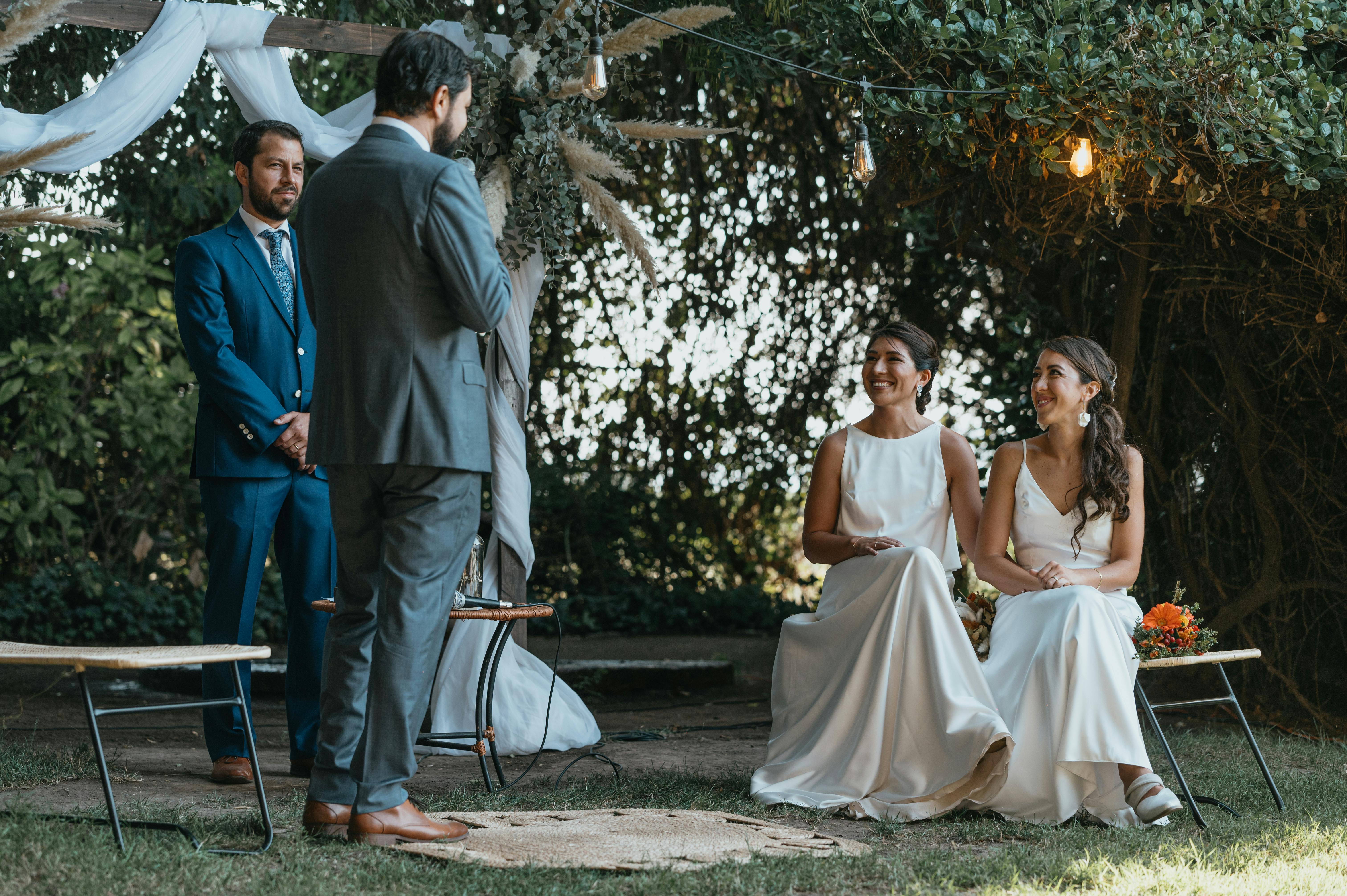 outdoor wedding ceremony with happy brides