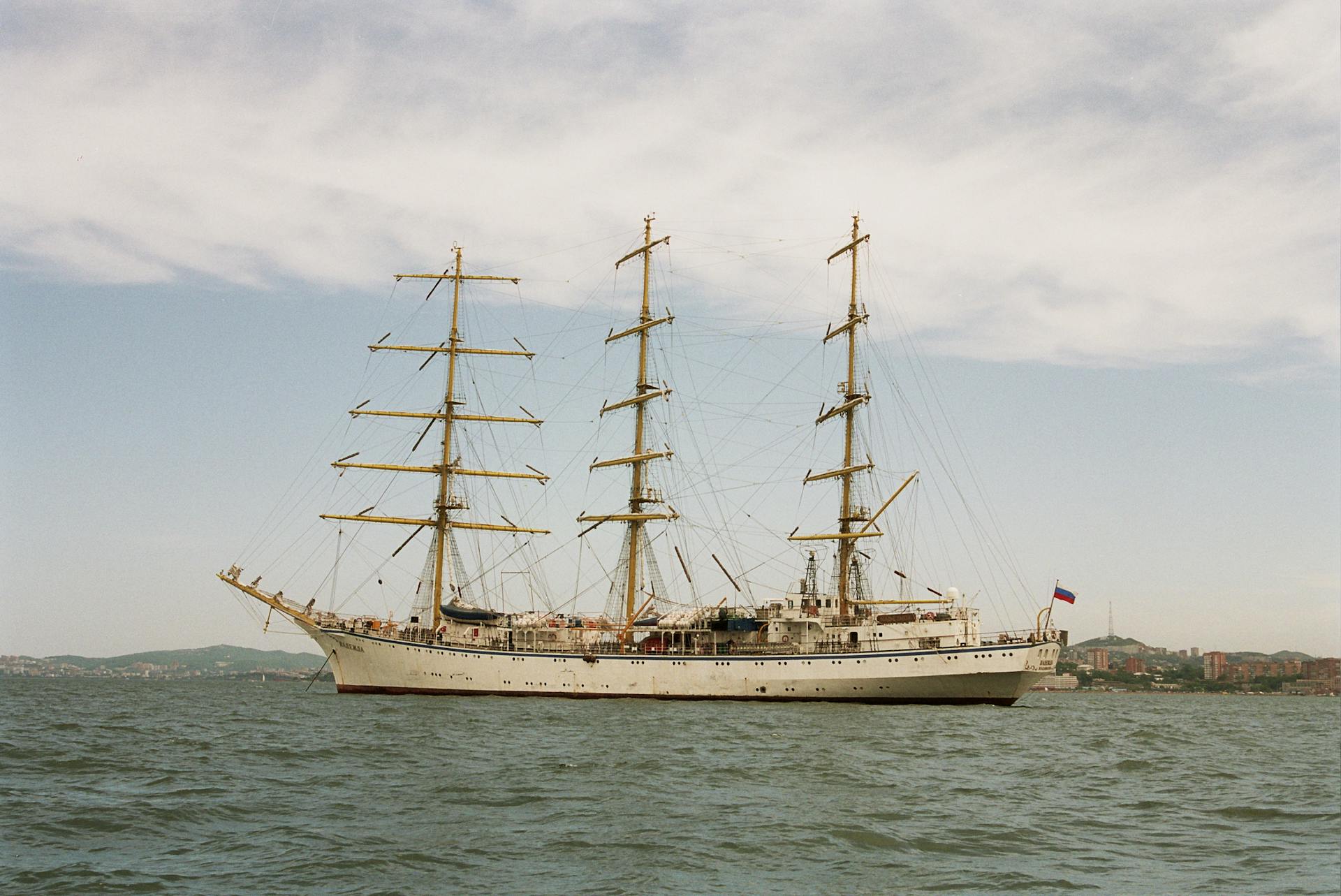 White Clipper Ship on Ocean Under Cloudy Sky