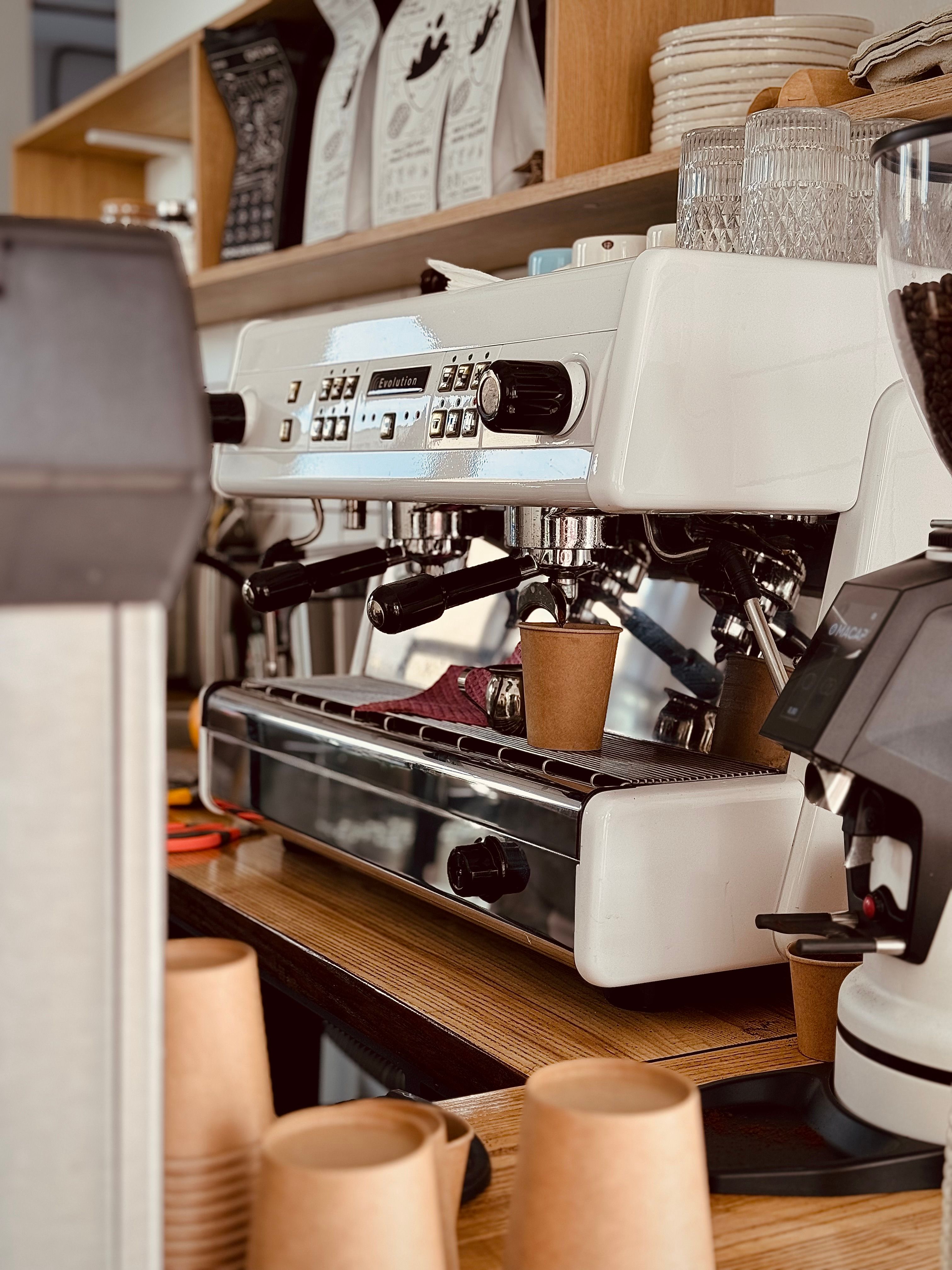 Stylish coffee shop in Kyiv with a modern espresso machine and takeaway cups. Perfect for café culture visuals.