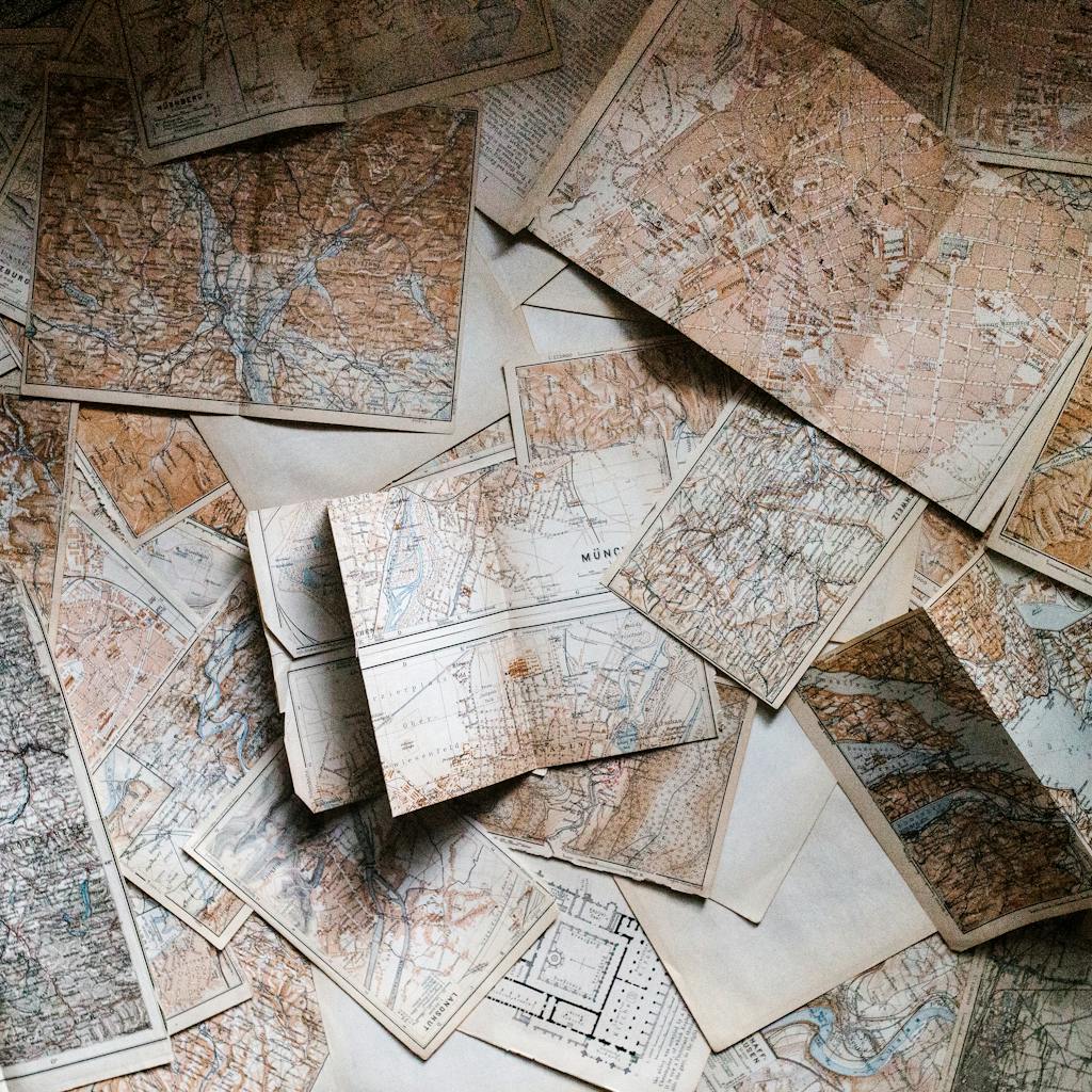 Pile of vintage maps, antique cartography, travel planning.