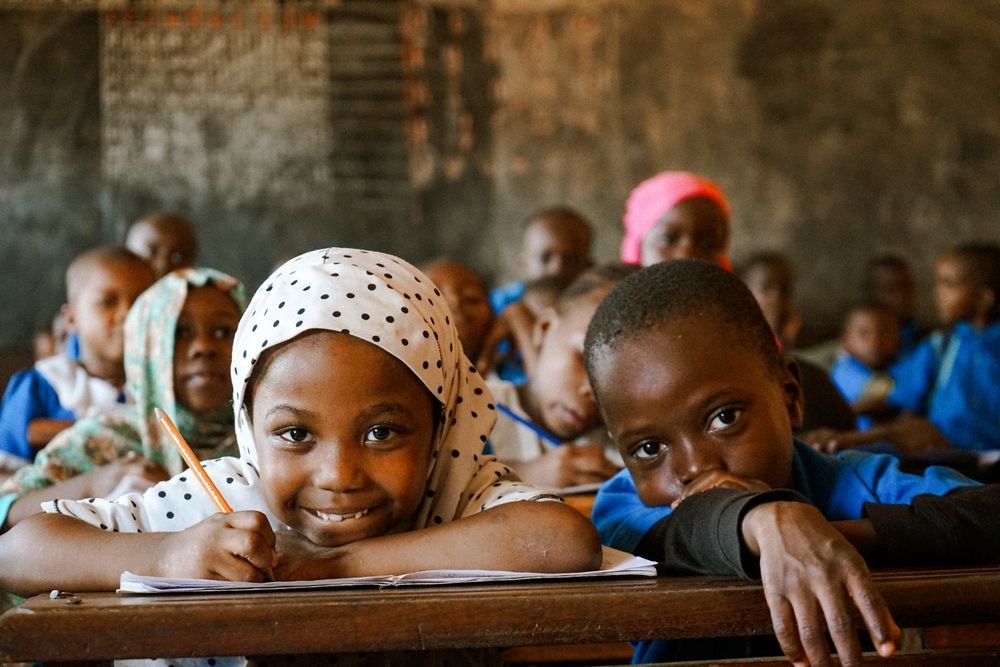 Smiling children learning together in a classroom