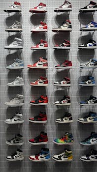 Vibrant display of assorted athletic shoes on a wall. Perfect for sneaker enthusiasts.