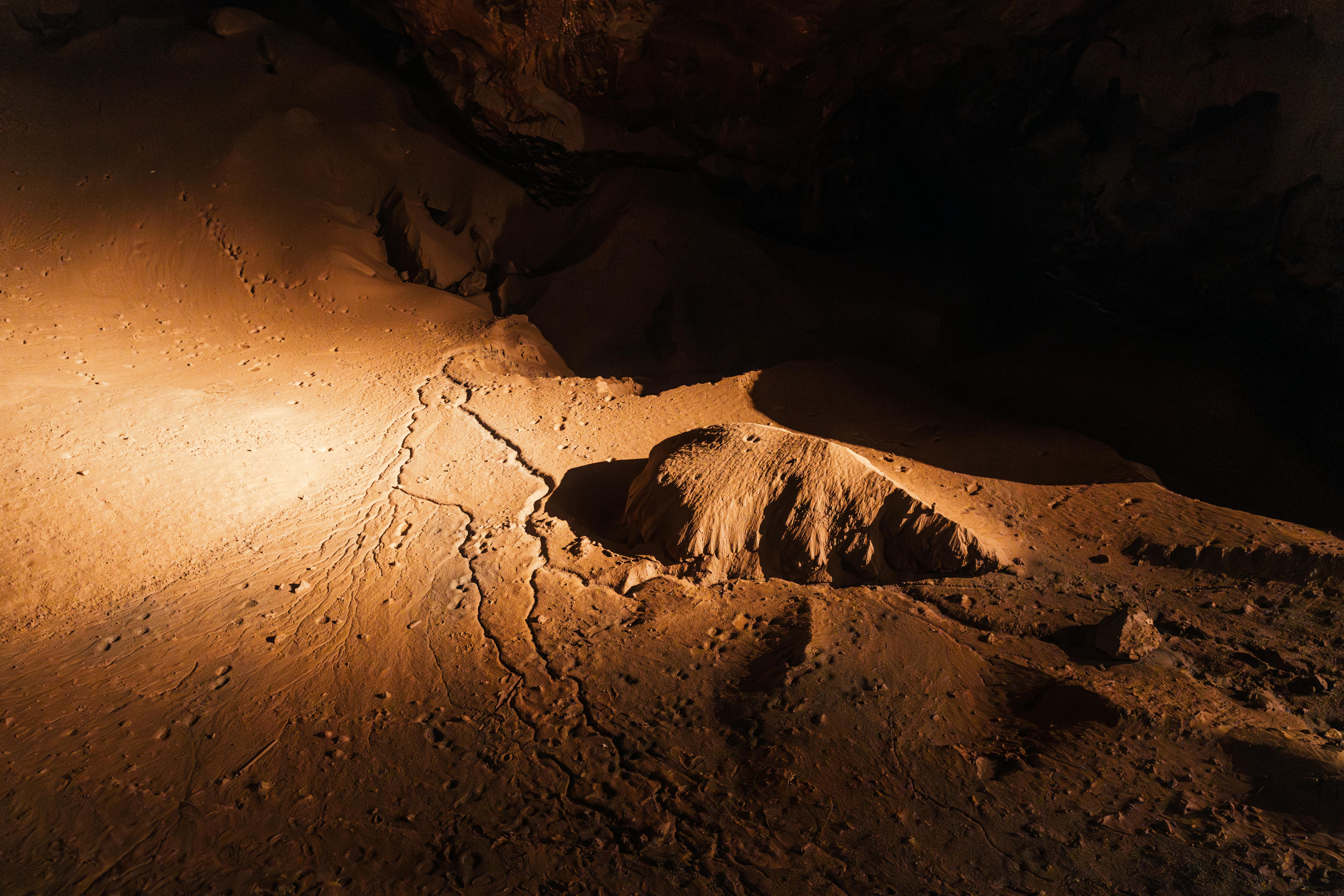 Explore the atmospheric underground cave formations in Новый Афон, highlighting unique textures.