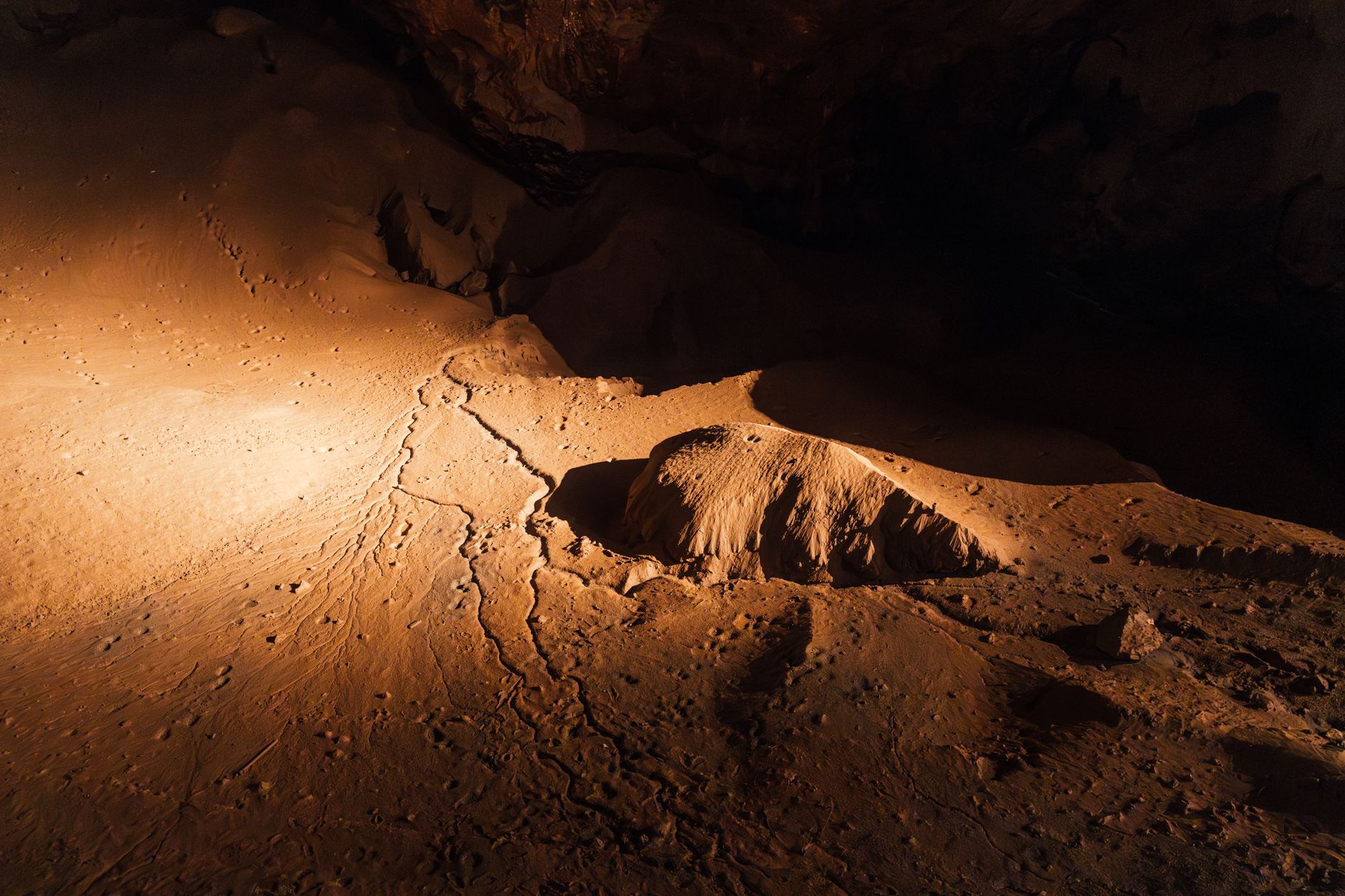 Explore the atmospheric underground cave formations in Новый Афон, highlighting unique textures.