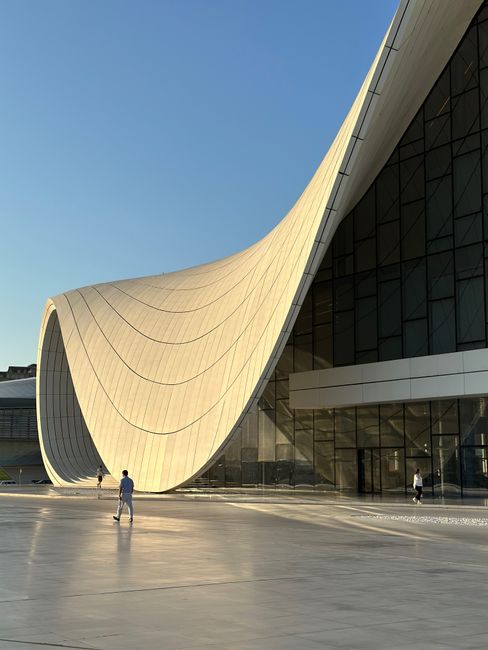 Stunning view of the Heydar Aliyev Center in Baku, Azerbaijan showcasing its iconic architecture during sunset.