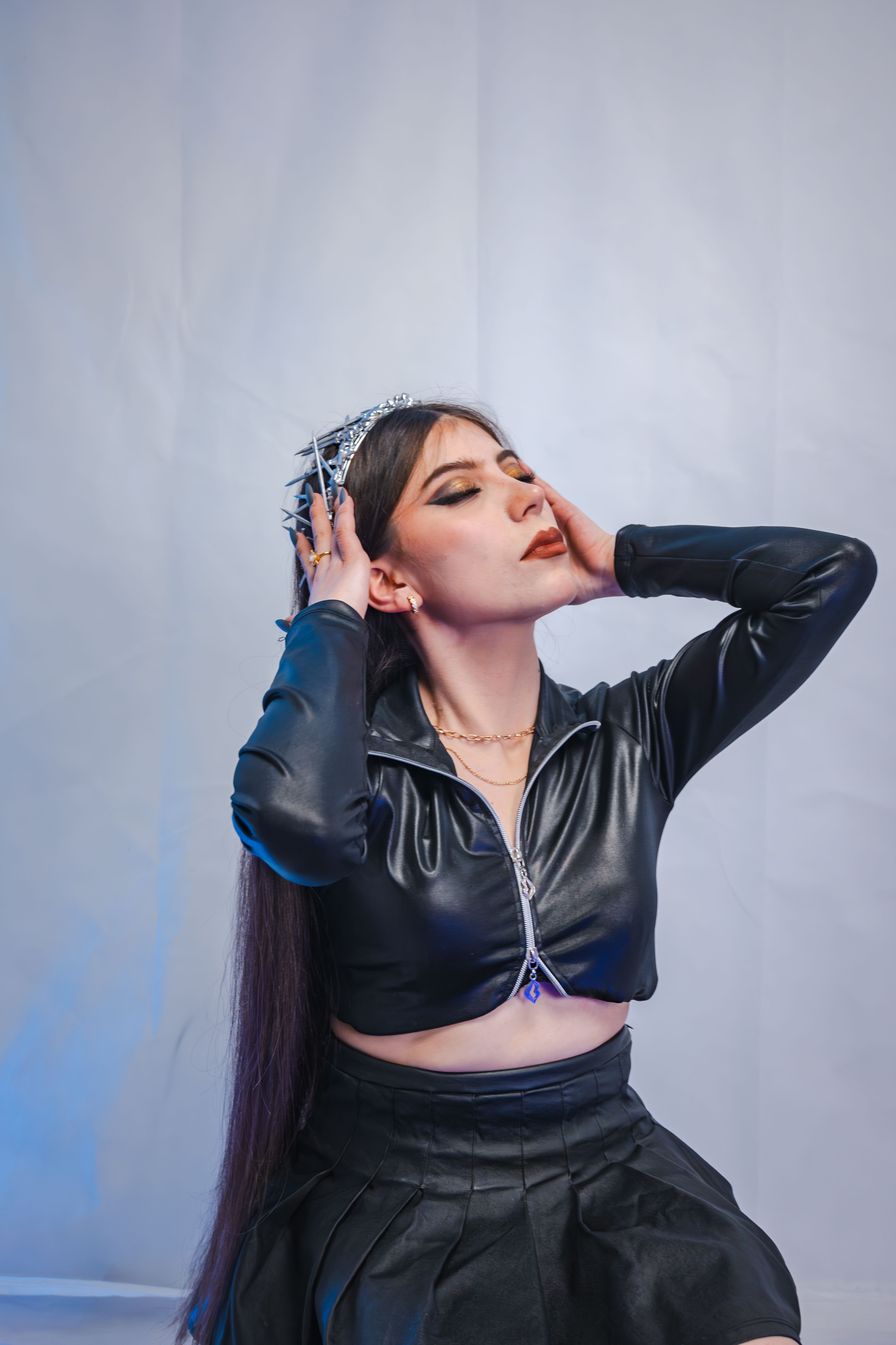 Woman in leather jacket with corset top and midi skirt