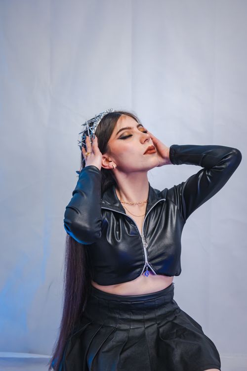 Woman in leather jacket with corset top and midi skirt
