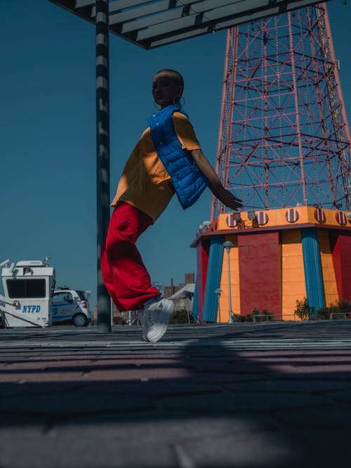 Woman Wearing Blue Vest Hopping