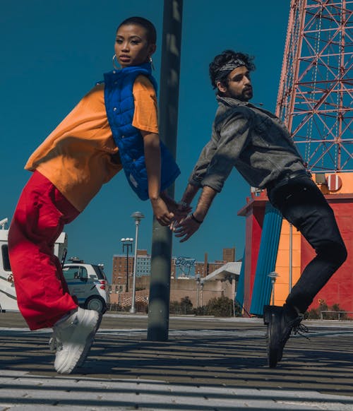 Man and Woman Tiptoeing on Street