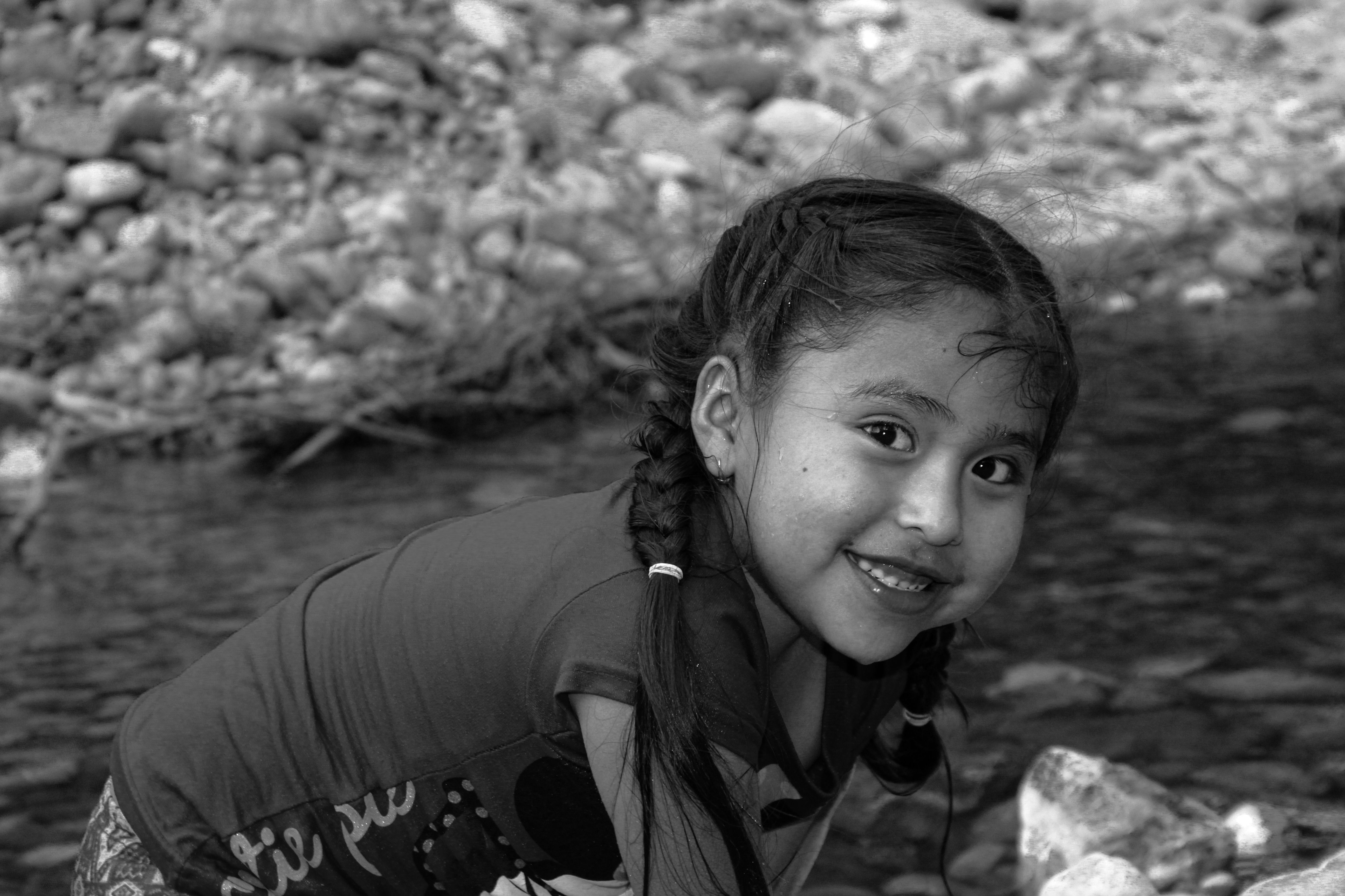 Smiling Girl by Riverside in Black and White · Free Stock Photo