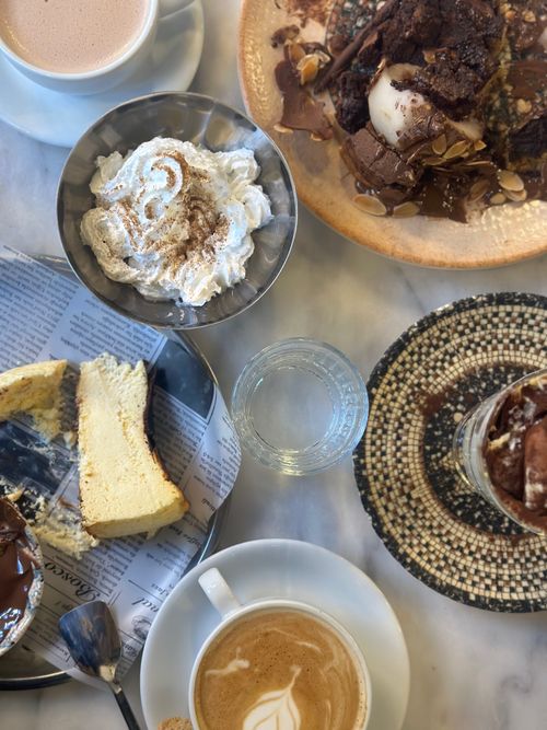 Free A tempting assortment of desserts and coffee elegantly arranged on a marble table, perfect for a sweet indulgence. Stock Photo