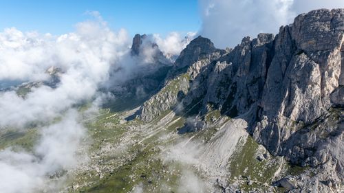 Free A stunning aerial view of the Dolomites with clouds and rocky formations. Stock Photo