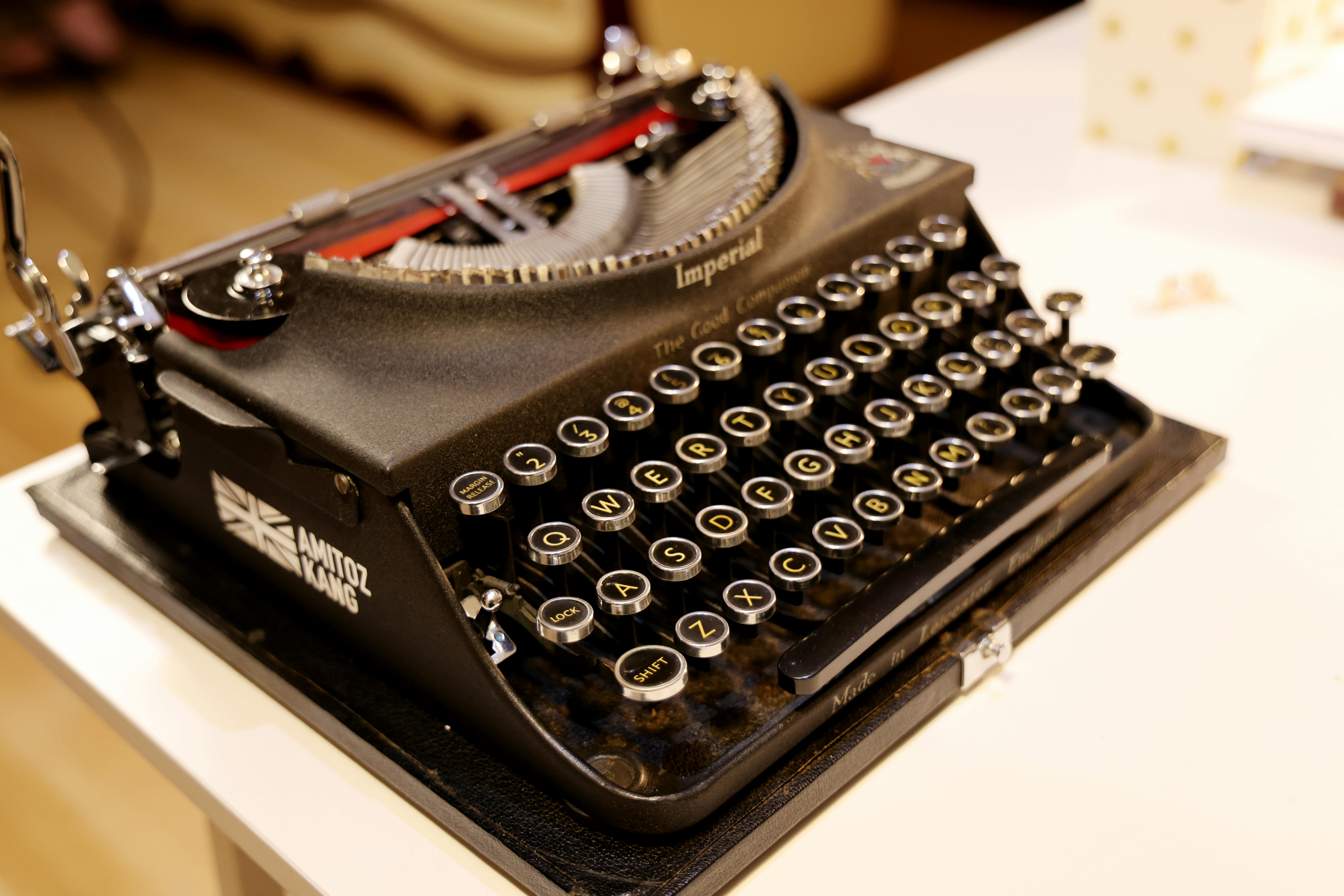Classic black Imperial typewriter on a desk, capturing a nostalgic and vintage feel.