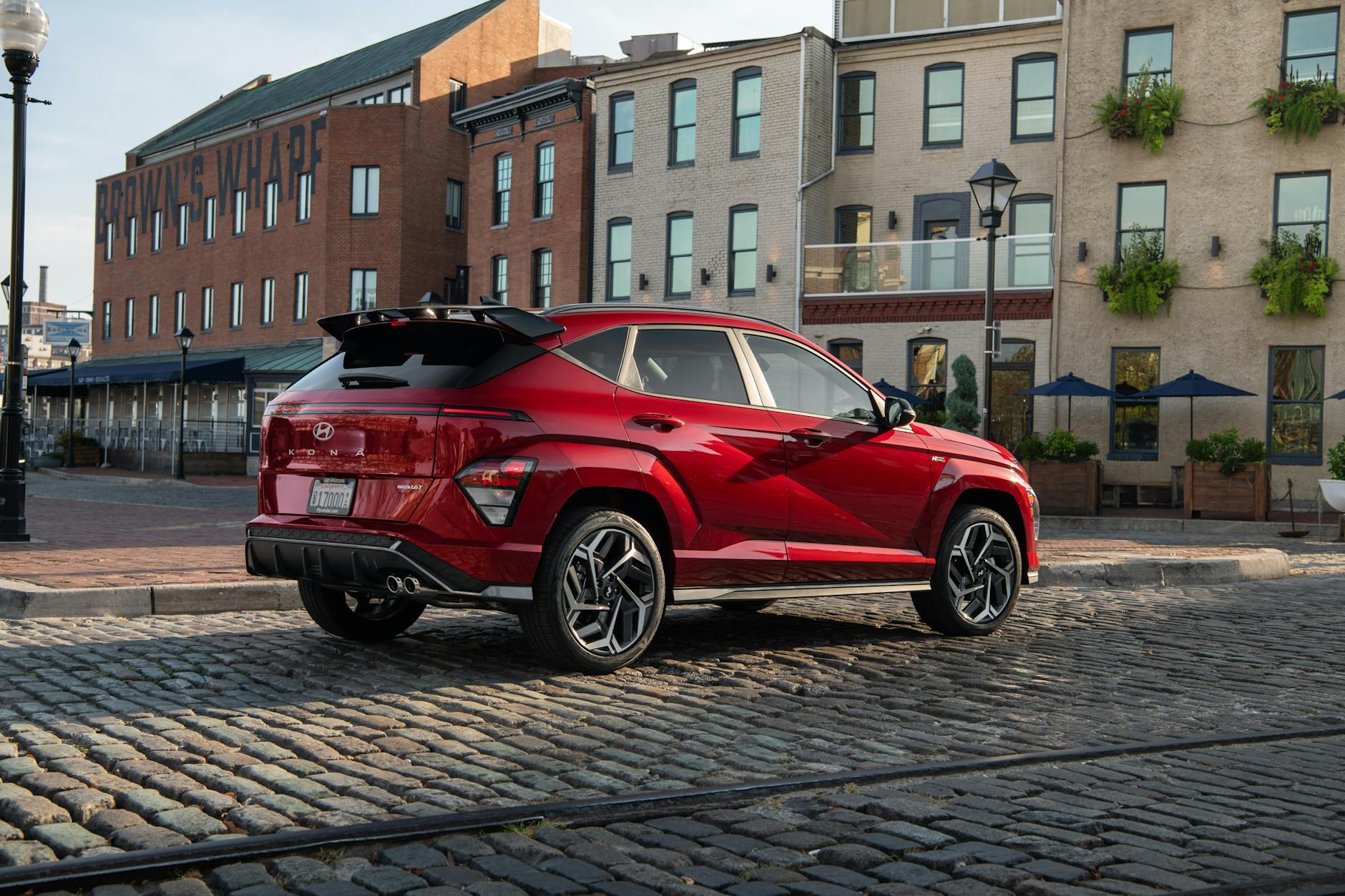 https://www.pexels.com/photo/red-hyundai-kona-parked-on-cobblestone-street-28599558/
