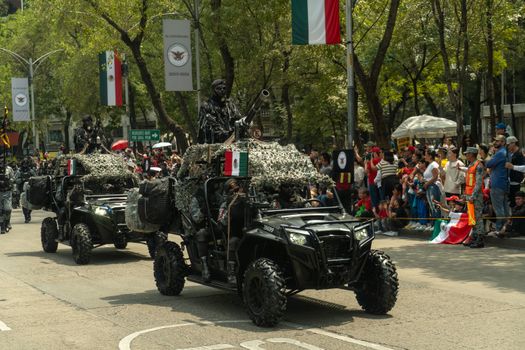Military vehicles in a parade on Avenida Reforma, Mexico City.