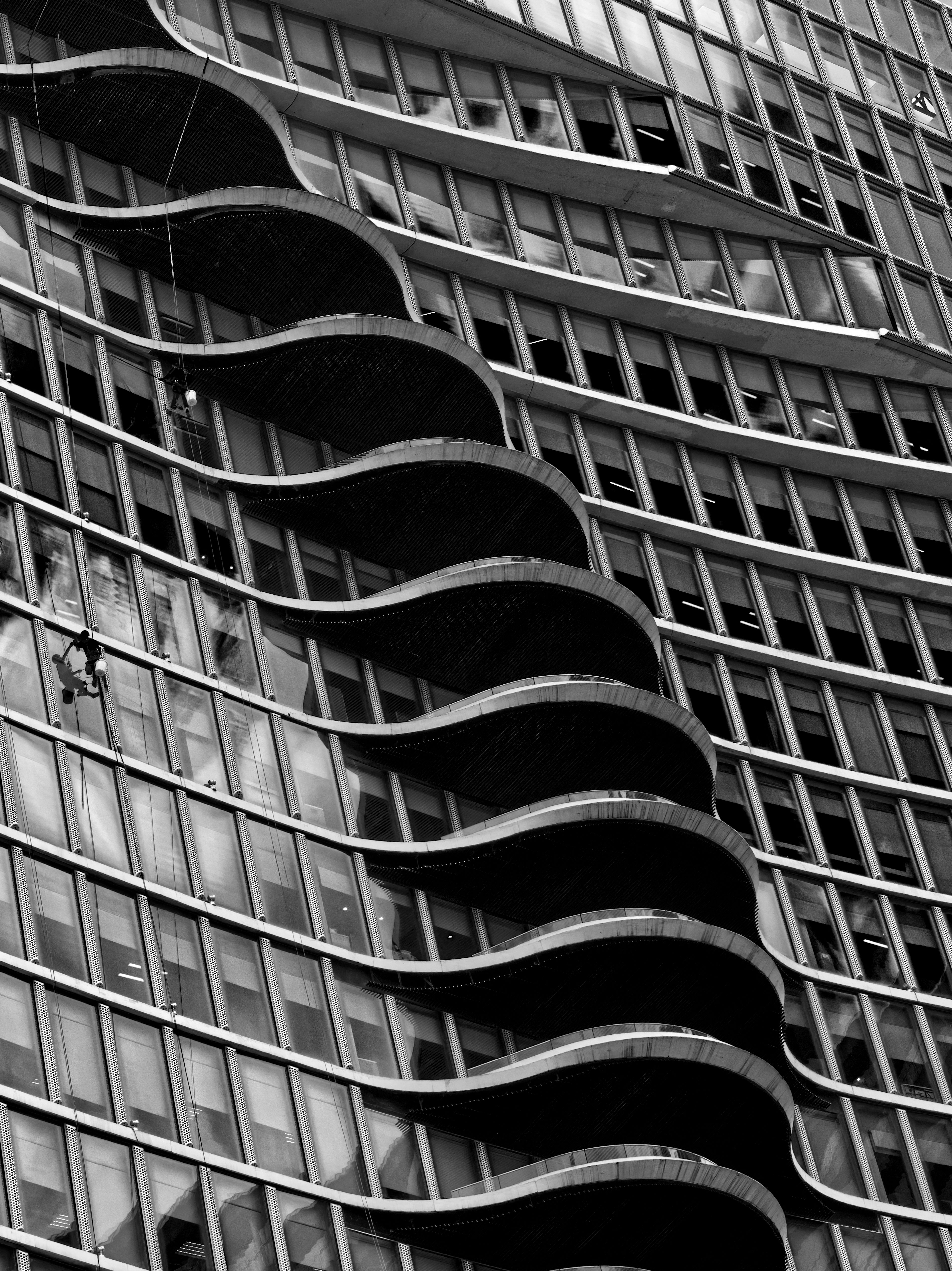 Striking black and white image of a modern building facade with unique architectural design.
