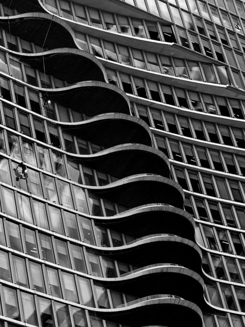 Striking black and white image of a modern building facade with unique architectural design.