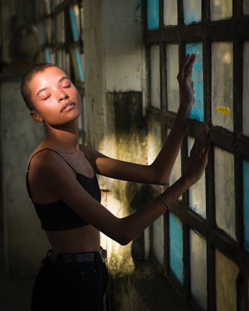 Woman Standing Beside Window