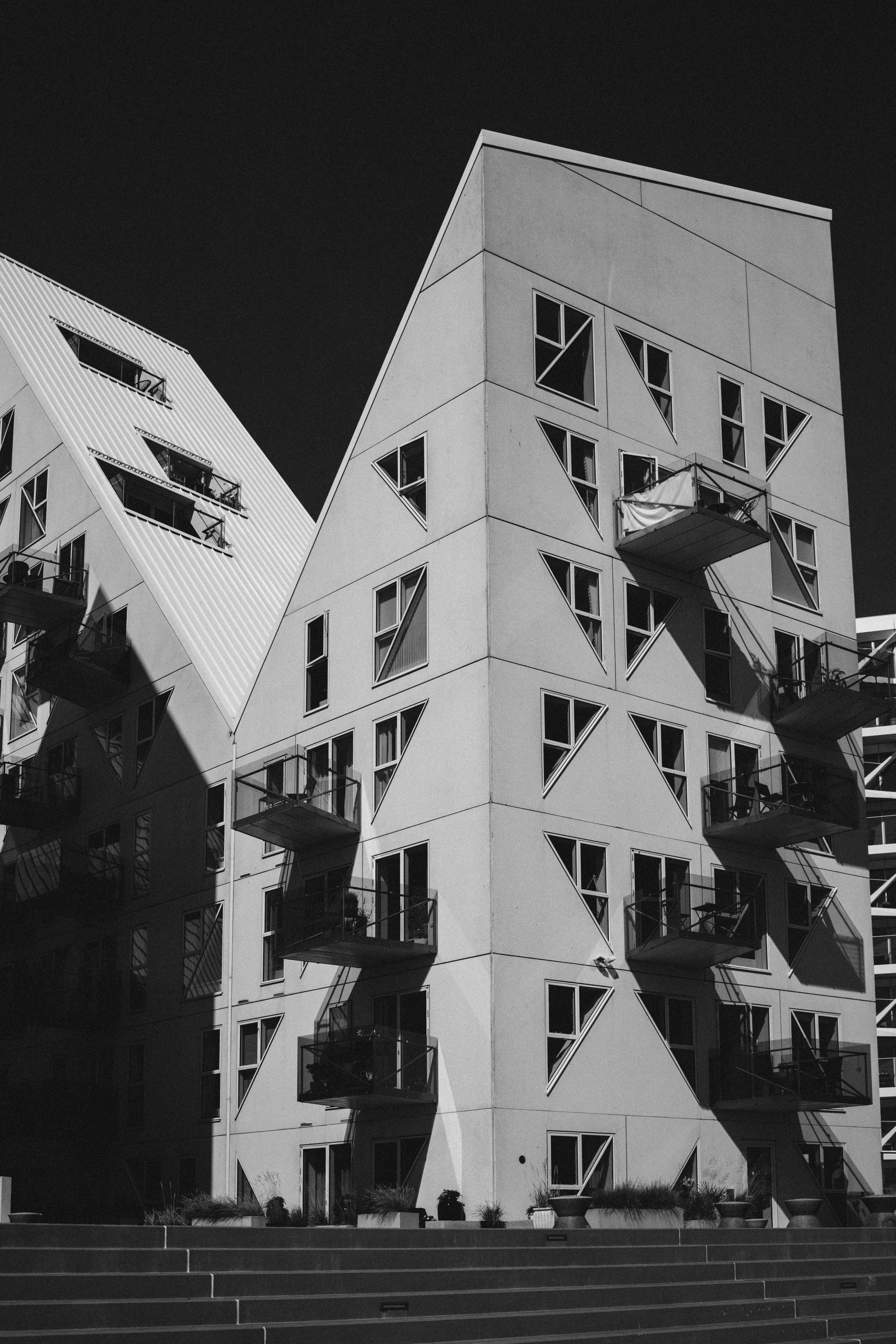 Striking black and white photo of modern geometric apartment architecture.