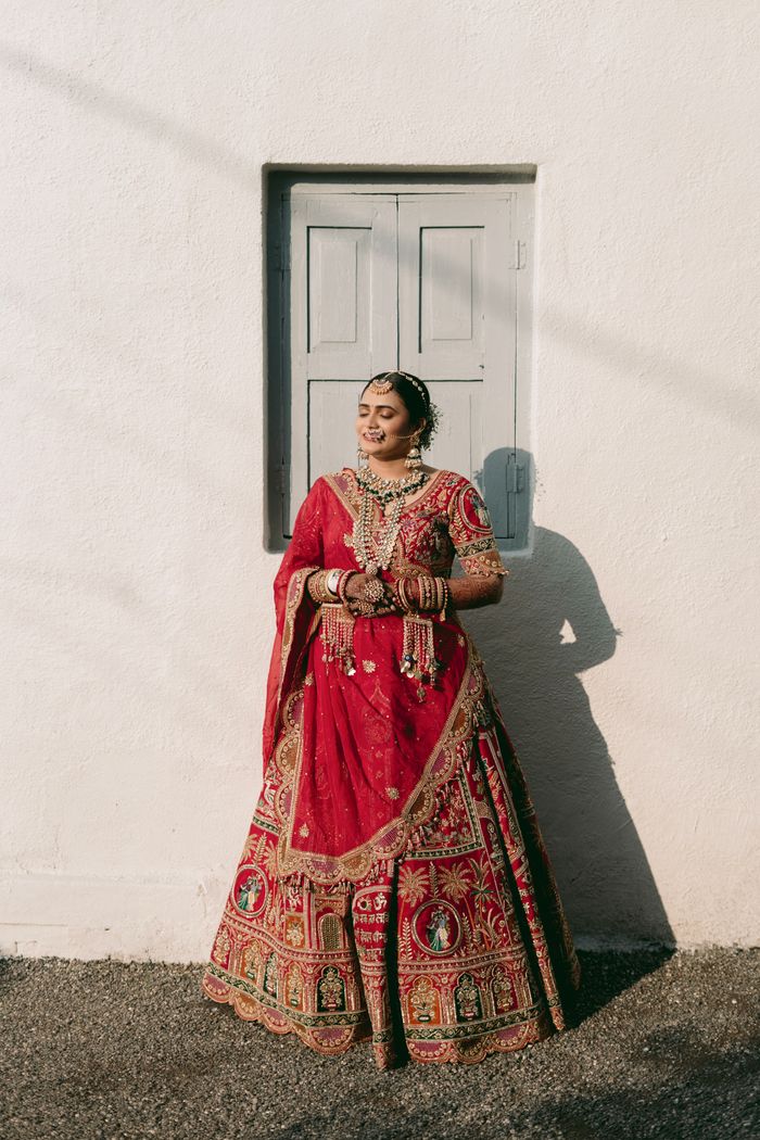 Elegant Indian bride in red lehenga outdoors