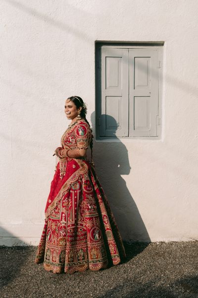 Smiling bride in red lehenga