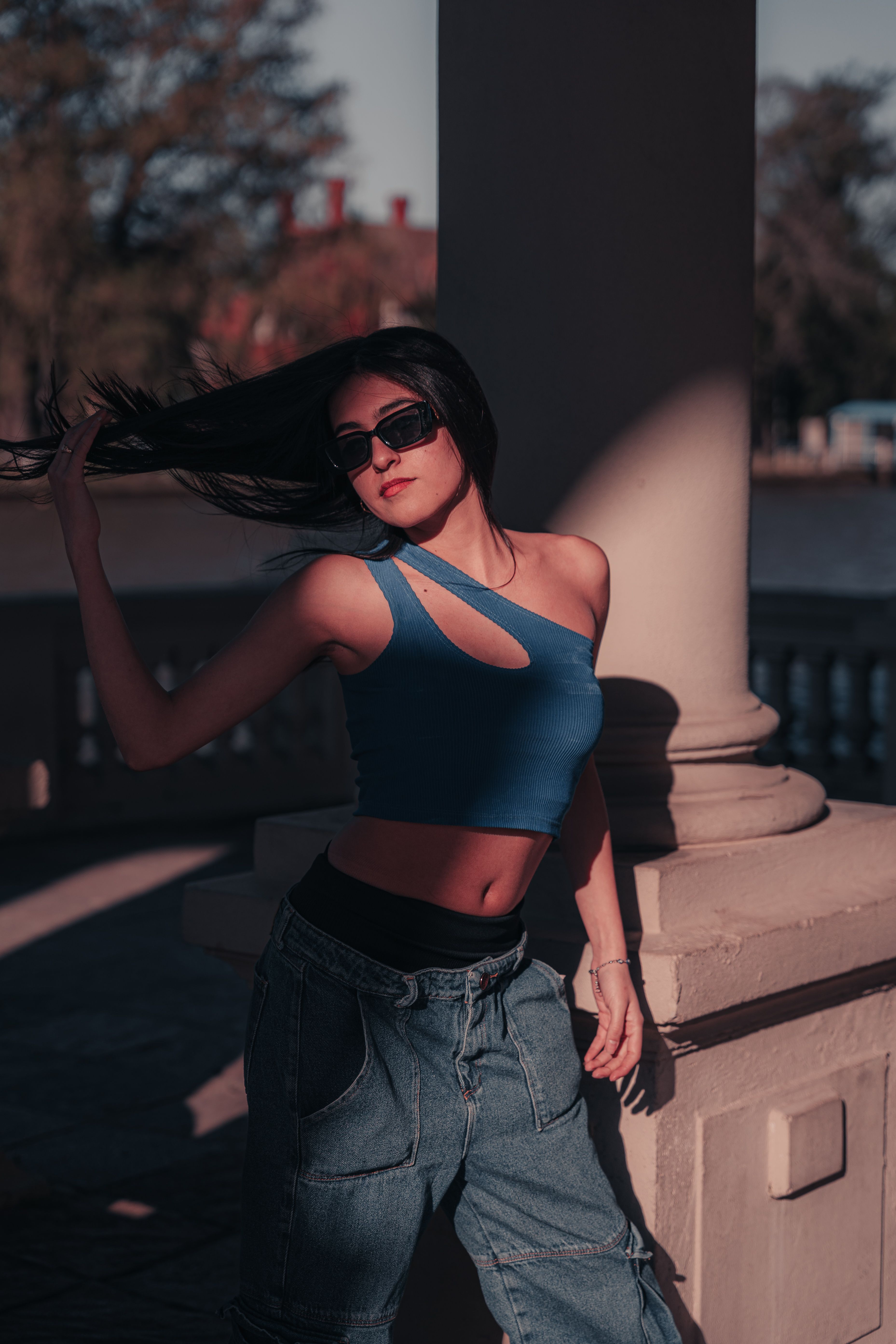 Stylish Woman Posing Outdoors in Sunglasses · Free Stock Photo