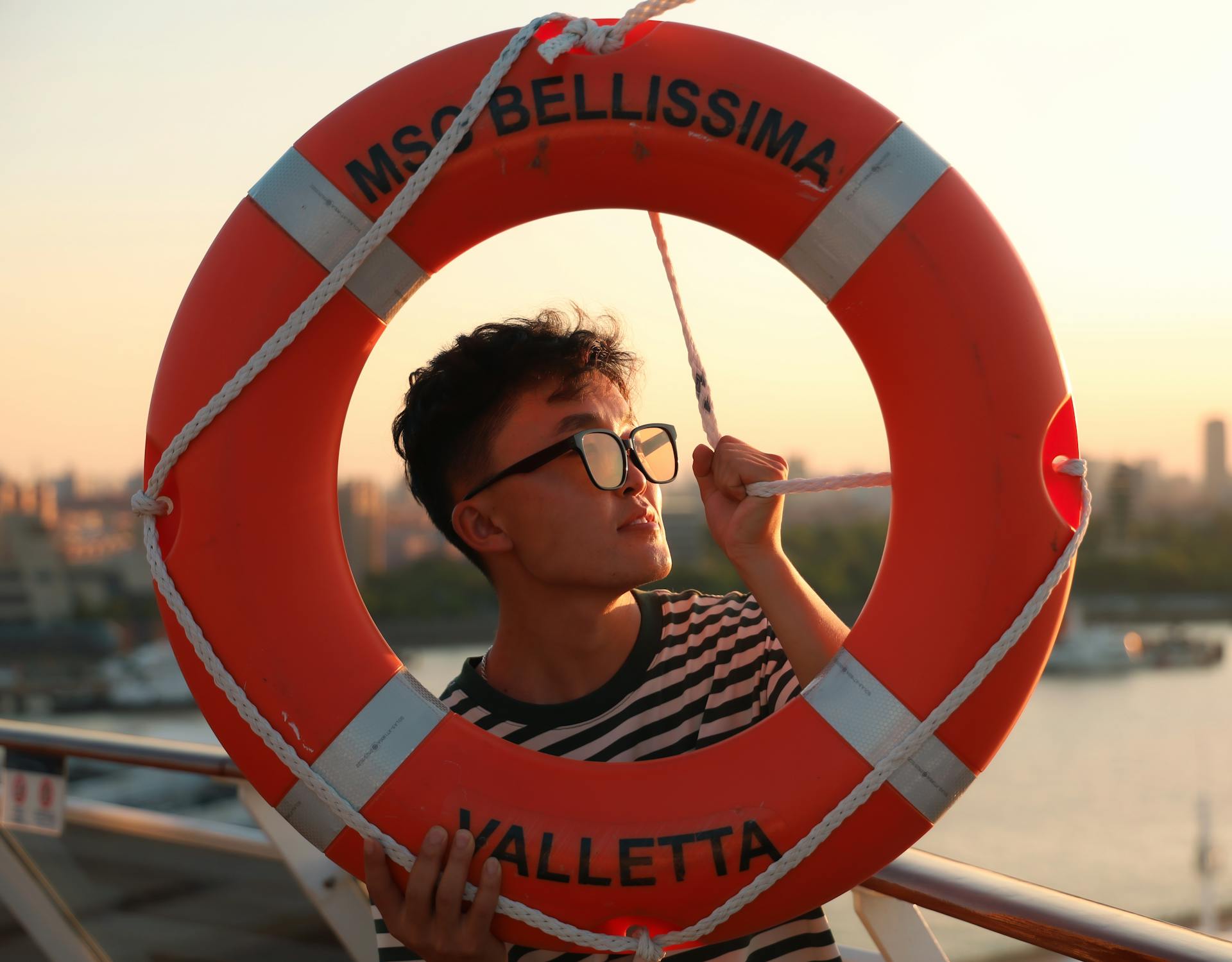 Man with Lifebuoy on MSC Bellissima at Sunset