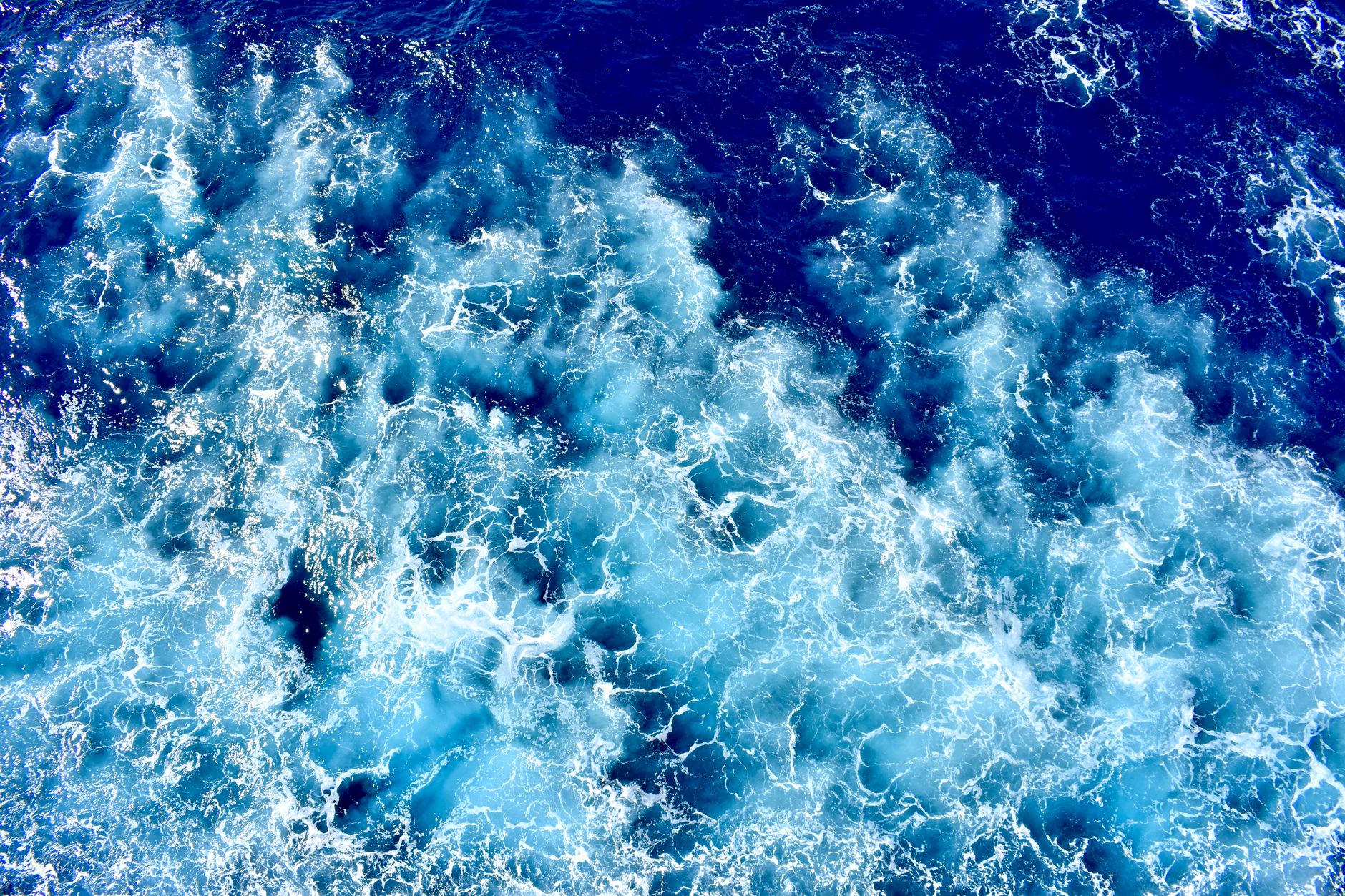Deep blue ocean waves seen from above