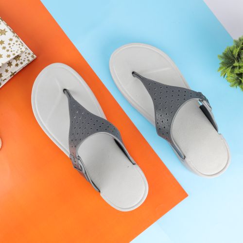 Free Gray flip-flops displayed on a vibrant orange and blue background, showcasing modern design and style. Stock Photo