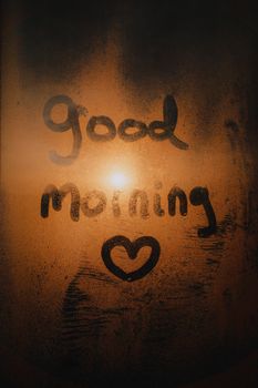 Heartfelt 'good morning' message drawn on a misty window.