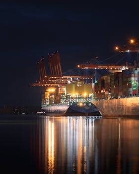 Nighttime view of container ships at Terminal Burchardkai in Hamburg, Germany.