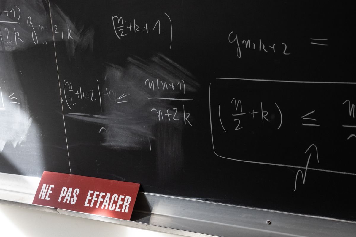 Mathematical formulas written in chalk on a classroom blackboard