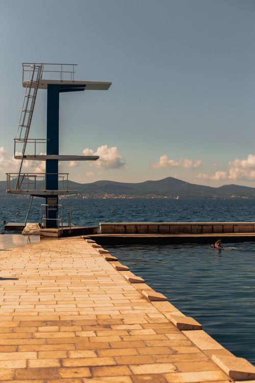 Free A diving platform on the waterfront in Zadar, Croatia, under a clear summer sky. Stock Photo