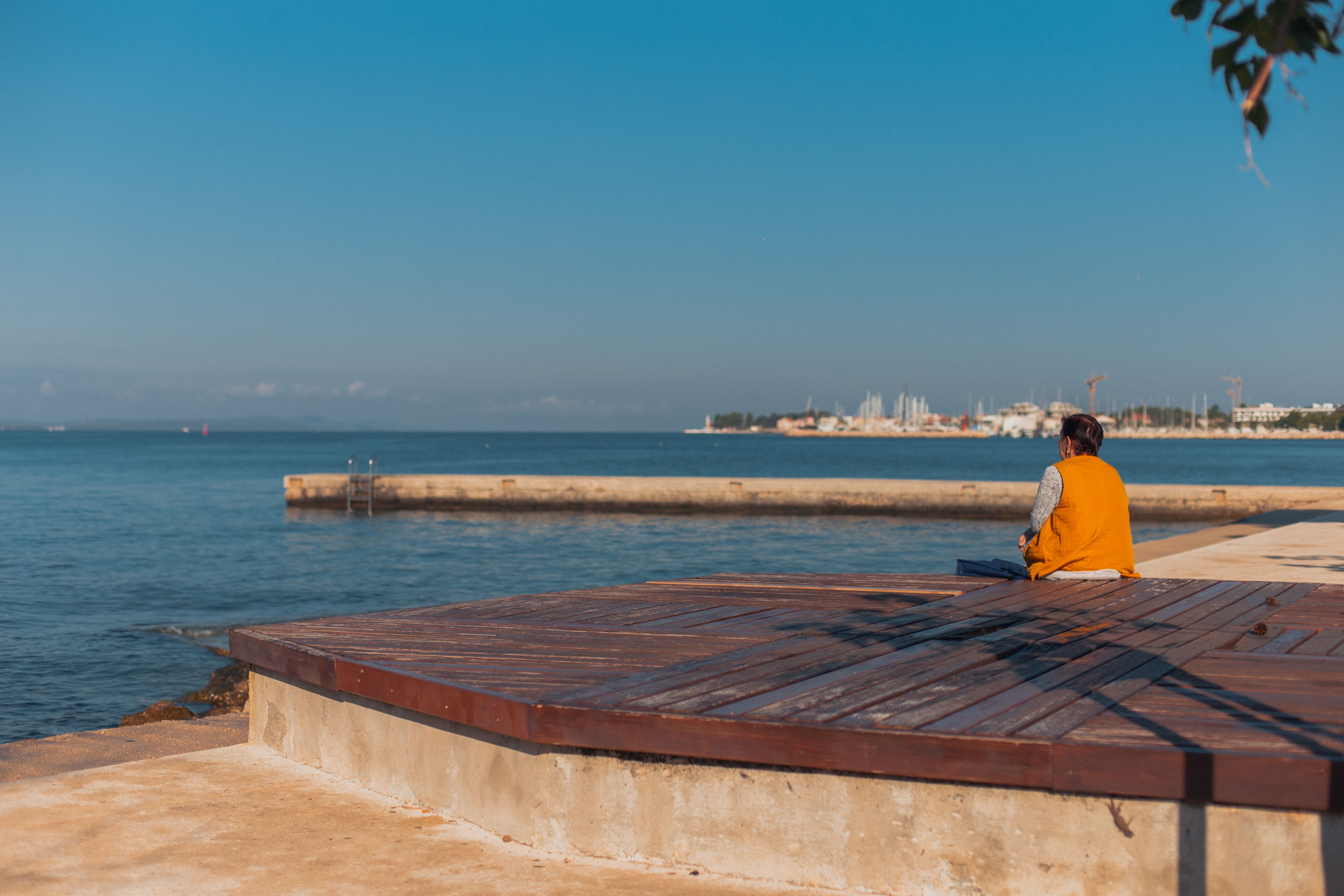 Person in thoughtful pose, looking thoughtfully into distance with calm expression