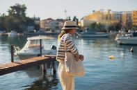 Woman enjoying a sunny day by the water in Zadar, Croatia.