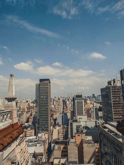 Free A captivating cityscape showcasing high-rise buildings against a bright blue sky. Stock Photo
